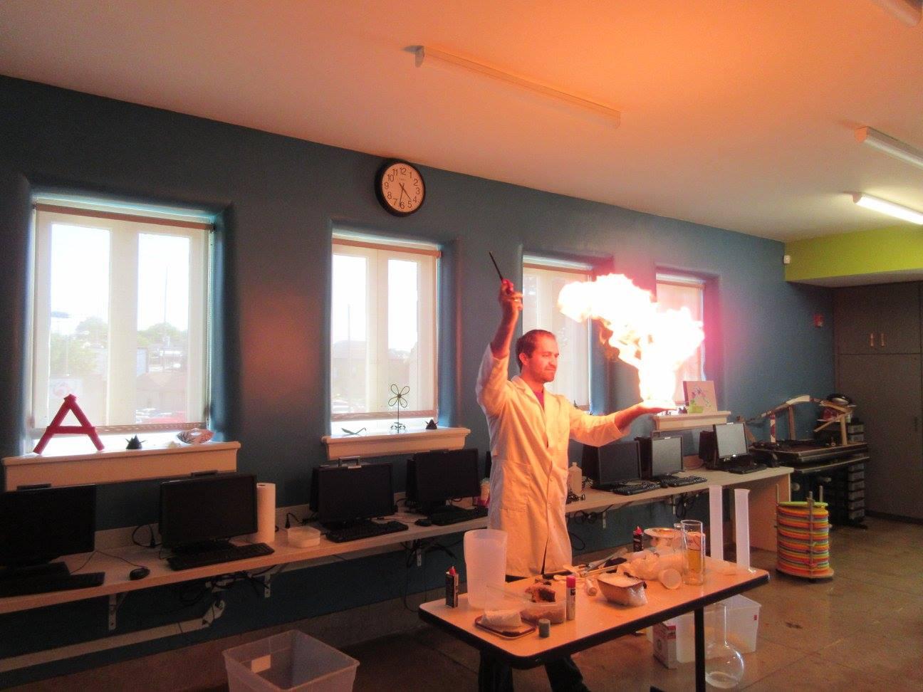 A scientist makes fire on the palm of his hand