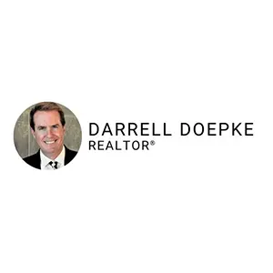 Portrait of a smiling man in a suit next to the text Darrell Doepke, REALTOR®.